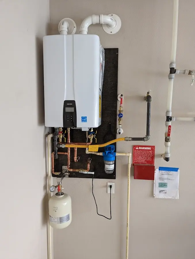 Professional plumber installing copper piping in a Valley Falls home